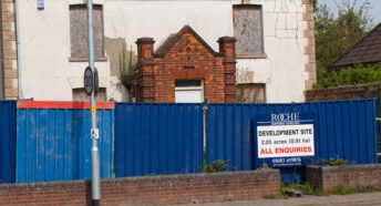 Sign sale of development at a derelict property