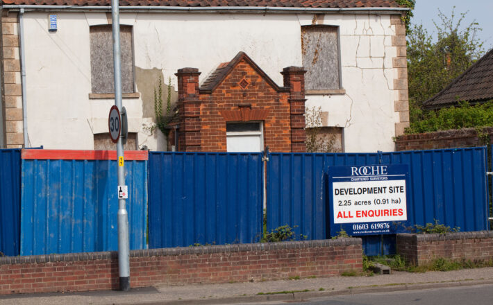 Sign sale of development at a derelict property