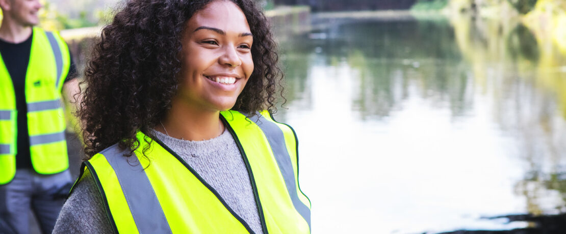 A volunteer litter picker working on a waterway