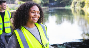 A volunteer litter picker working on a waterway