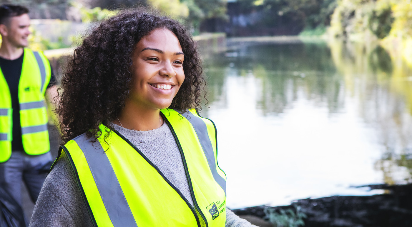 A volunteer litter picker working on a waterway