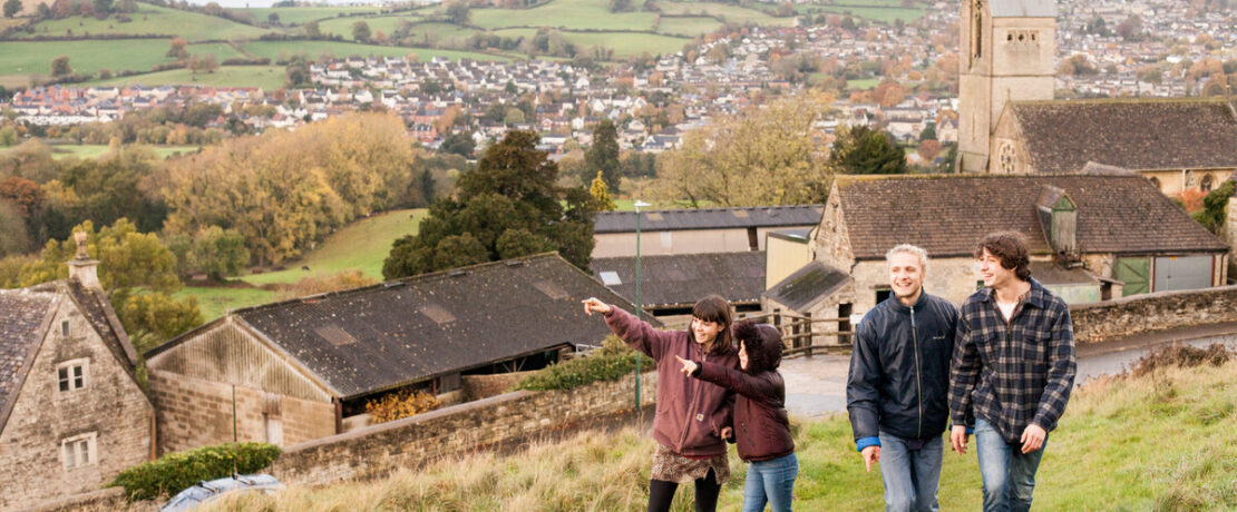 Group of teens and a young girl on a walk in the countryside in the cotswolds - greenbelt