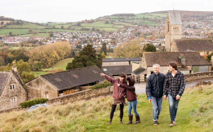 Group of teens and a young girl on a walk in the countryside in the cotswolds - greenbelt