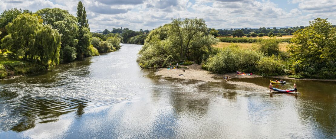 View of a river on a sunny day with some small canoes