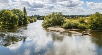 View of a river on a sunny day with some small canoes