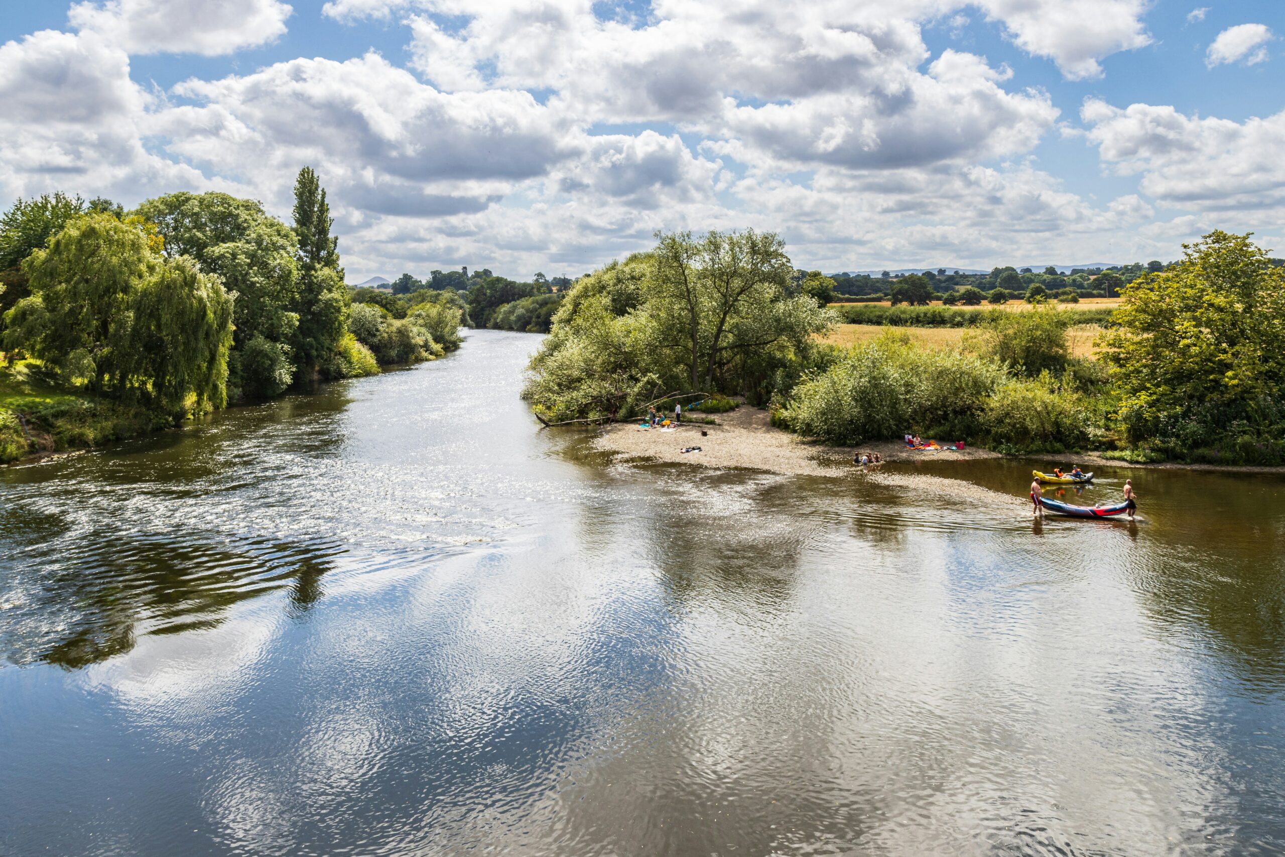 View of a river on a sunny day with some small canoes