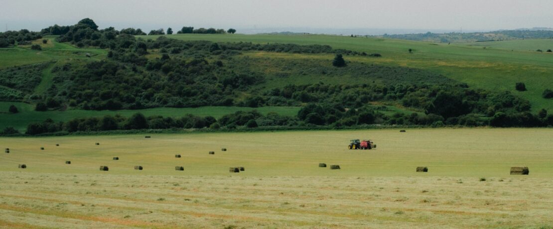 Tractor mowing in a large field